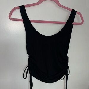 Size large black tank top with adjustable string ties on side to adjust crop